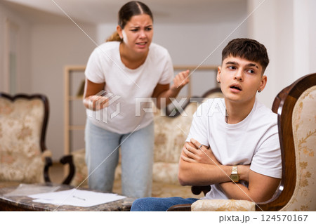 Angry young woman swears at her spouse Angry young woman swears at her spouse 124570167