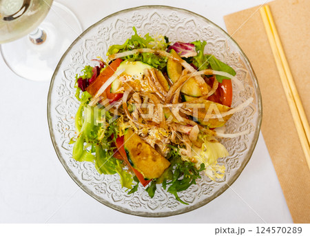 Japanese salad with tomatoes, cucumbers and onions closeup 124570289