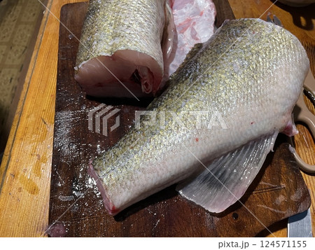 Fresh zander fish filleting on wooden board Fresh zander fish filleting on wooden board 124571155