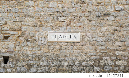 Citadela word inscription sign on stone wall in Budva Montenegro city. Travel tourist destination old town. Sea coastline in a tourist city on the Adriatic 124572314