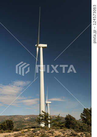 a wind turbine against the background of the blue sky 124573063