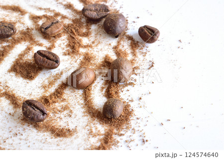 Coffee beans and ground coffee are scattered on the table. Coffee beans and ground coffee are scattered on the table. 124574640