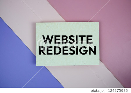 Website Redesign text on paper card on purple and pink geometric background 124575986