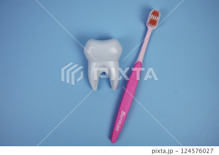 Toothbrush and Tooth dental hygiene concept top view on blue background 124576027