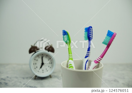 Toothbrush with alarm clock dental hygiene concept on marble background 124576051