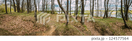 Old Abandoned World War Ii Trenches At Riverside Since Second World War. Early Spring Season. Cloudy Blue Sky. Memory Of War. Old Infantry Fortifications. Ruined Line Of Defense. Panoramic View Old Abandoned World War Ii Trenches At Riverside Since Second World War. Early Spring Season. Cloudy Blue Sky. Memory Of War. Old Infantry Fortifications. Ruined Line Of Defense. Panoramic View 124577564