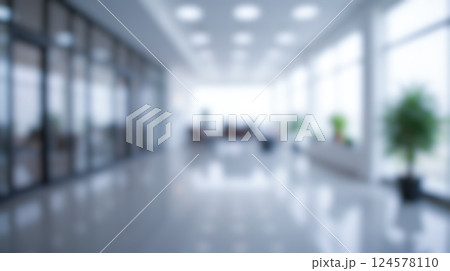 Blurred office environment with natural light, spacious interior, modern furniture, glass walls, indoor plants, and professional work atmosphere for business visual 124578110