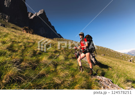 Girl Traveler hiking with backpack at rocky mountains landscape Travel Lifestyle concept adventure summer vacations outdoor 124578251