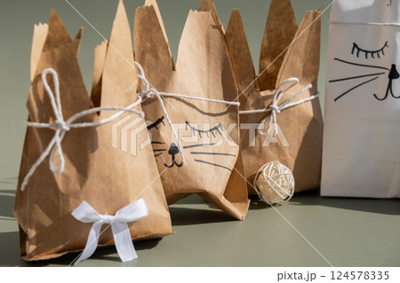 DIY candid Easter present paper bag bunny arrangement decor. Series of handmade craft paper gift idea instruction manual activity for children. Zero waste eco-friendly springtime 124578335