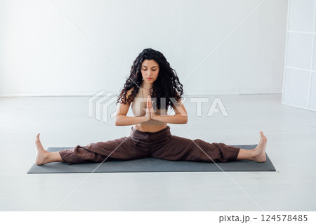 Brunette Yoga Woman Doing Asana Gymnastics On Floor 124578485