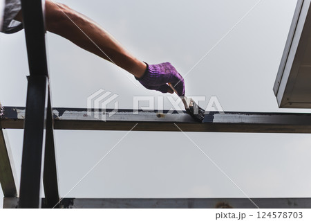 Hand painting anti rust paint on steel at home decorated. 124578703