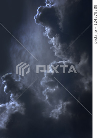 Vertical Dramatic dark storm rain clouds black sky background. Dark thunderstorm clouds rainny atmosphere. windstorm disasters climate. Dust ominous cloudscape storm disaster gloomy gray cloud sky 124579589