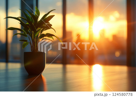 Office plant in sunlight with blurred figures in background 124580778