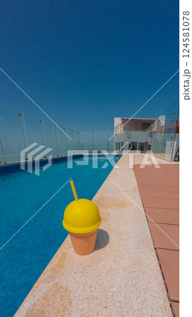 Ice cream cup by the pool on a summer day Ice cream cup by the pool on a summer day 124581078