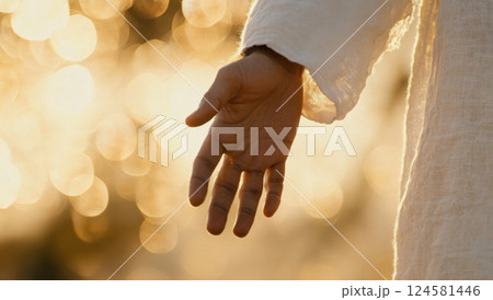 Hand of Jesus reaching out with light in spiritual scene, copy space background 124581446