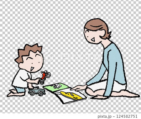 A boy playing with car and motorbike toys and a train picture book 124582751