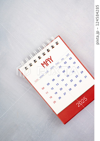 May 2025 on gray wooden table, Flat lay. 124584285