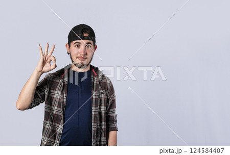 Young man making ok gesture, expression of everything is fine, Concept of no problem 124584407