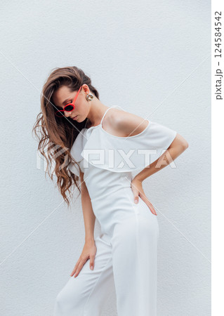 Beautiful slim woman with glasses on a white background 124584542