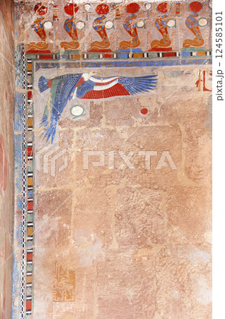 Ancient Colorful Mural Wall Painting inside Hatshepsut Temple in Valley of the Kings, Luxor, Egypt. Figure of the eagle and cobras, wall of the Hatshepsut temple in Western Thebes 124585101