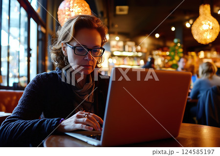 Woman working on laptop at cozy cafe. AI-generated item 124585197
