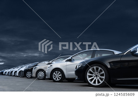 Cars on a background of dramatic sky. A symbol of the crisis in the automotive industry Cars on a background of dramatic sky. A symbol of the crisis in the automotive industry 124585609