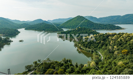 Kaeng Krachan dam with lake view and many green moutain, blue sky background. Kaeng Krachan Dam national park, Phetchaburi province, Thailand in aerial view from drone. Kaeng Krachan dam with lake view and many green moutain, blue sky background. Kaeng Krachan Dam national park, Phetchaburi province, Thailand in aerial view from drone. 124585889