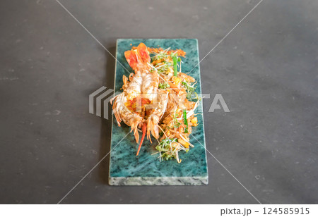 Lobster Pad Thai is served with yellow noodle, fried tofu, cress, bean sprouts, chilli power, garlic chives, and lime put on a rectangular plate. Lobster Pad Thai is served with yellow noodle, fried tofu, cress, bean sprouts, chilli power, garlic chives, and lime put on a rectangular plate. 124585915