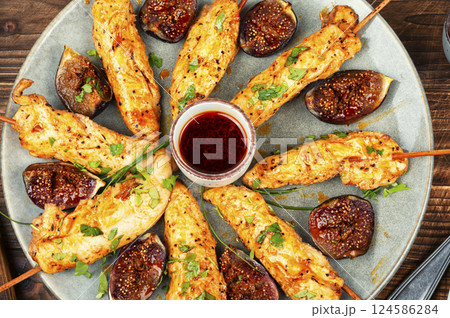 Grilled chicken on bamboo skewers. 124586284