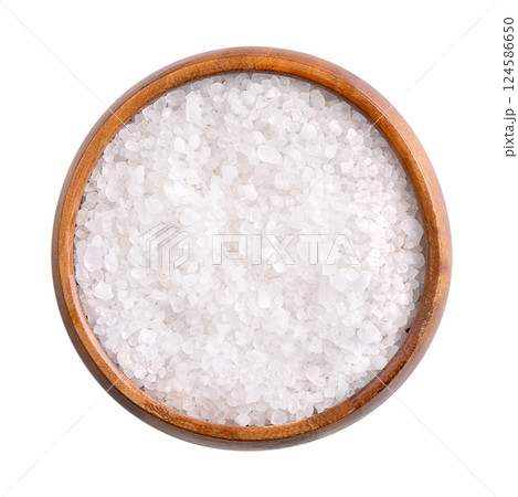 Coarse Dead Sea salt in wooden bowl, isolated, from above. Crystalized salt extracted from the Dead Sea, rich in chloride, magnesium, sodium, calcium and potassium. Used as bath salt and in cosmetics. 124586650