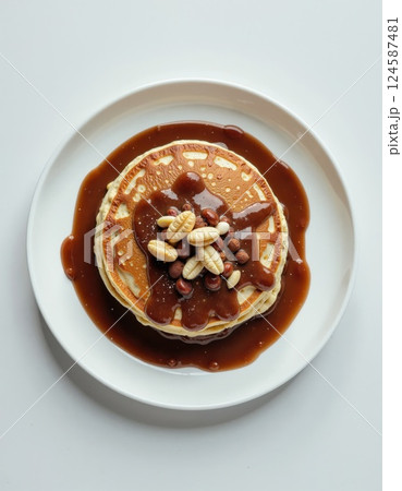 Gourmet pancake stack with honeycomb and nuts in rich caramel drizzle perfect for autumn brunch themes and comfort food concepts 124587481