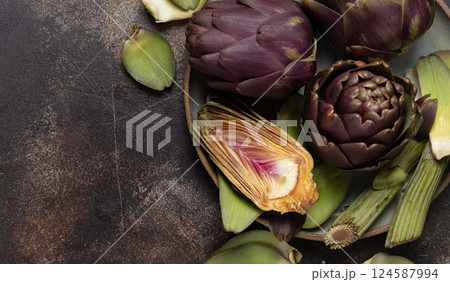 Plate full of cut purple raw artichokes top view. Fresh italian vegetables from farmers market 124587994
