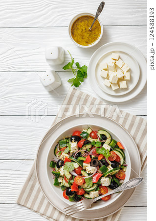 greek salad of veggies, olives, cheese in bowl greek salad of veggies, olives, cheese in bowl 124588193