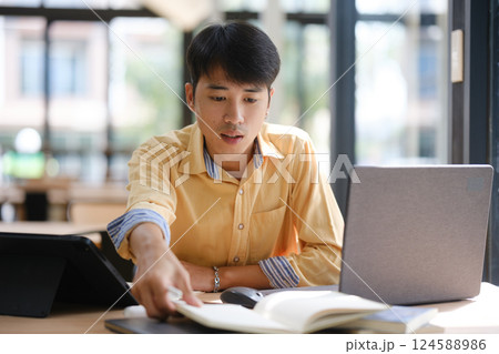 asian businessman working on laptop in office asian businessman working on laptop in office 124588986