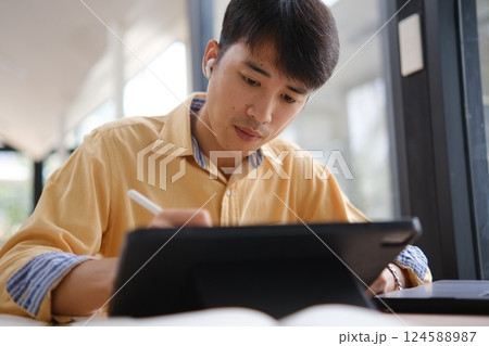 University student studying online and preparing for exams. University student studying online and preparing for exams. 124588987