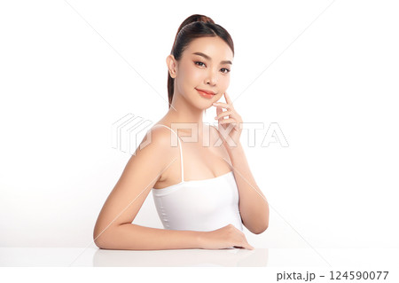 A beautiful young Asian woman with clean, fresh skin against a white background. Skincare, facial treatment, cosmetology, beauty, and spa. An elegant portrait of an Asian woman. 124590077