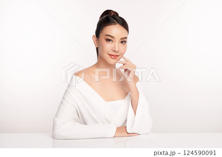 A beautiful young Asian woman with clean, fresh skin against a white background. Skincare, facial treatment, cosmetology, beauty, and spa. An elegant portrait of an Asian woman. A beautiful young Asian woman with clean, fresh skin against a white background. Skincare, facial treatment, cosmetology, beauty, and spa. An elegant portrait of an Asian woman. 124590091