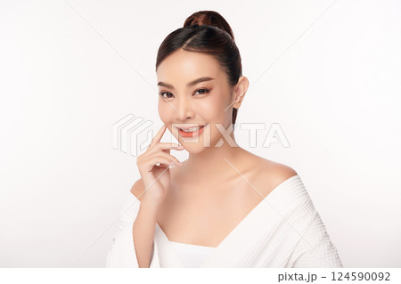 A beautiful young Asian woman with clean, fresh skin against a white background. Skincare, facial treatment, cosmetology, beauty, and spa. An elegant portrait of an Asian woman. A beautiful young Asian woman with clean, fresh skin against a white background. Skincare, facial treatment, cosmetology, beauty, and spa. An elegant portrait of an Asian woman. 124590092
