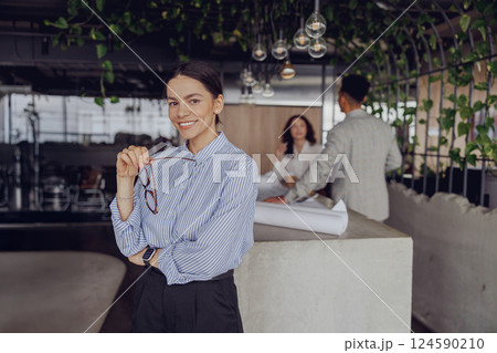 A Professional Woman Engaged in a Contemporary Office Environment, Embracing Modern Design A Professional Woman Engaged in a Contemporary Office Environment, Embracing Modern Design 124590210