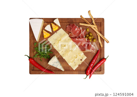 Cheese board isolated on white table. Different types of cheese, chili, jamon, olive, microgreens, knife, bread sticks. Snack. View from above. 124591004