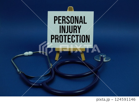 Personal Injury Protection text message on paper card with stethoscope on wooden background 124591146