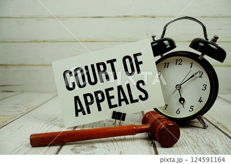 Court Of Appeals text message on paper card with wooden gavel and alarm clock on wooden background Court Of Appeals text message on paper card with wooden gavel and alarm clock on wooden background 124591164