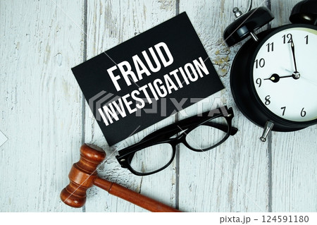 Fraud Investigation text on paper card with alarm clock and wooden judge gavel top view on wooden background Fraud Investigation text on paper card with alarm clock and wooden judge gavel top view on wooden background 124591180
