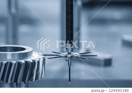 The CMM machine measuring the metal gear parts by modular probe in the light blue scene. 124591190