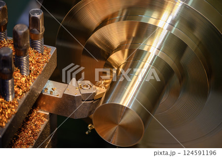 Close up scene the lathe machine finish cut the brass material parts. Close up scene the lathe machine finish cut the brass material parts. 124591196