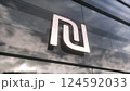 Israel Shekel currency sign on a modern glass skyscraper. Business and finance concept. 3d illustration 124592033
