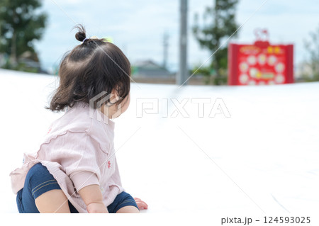 【巨大な遊具でお座りする乳幼児】 124593025