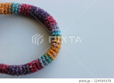 The bend of a twine woven from colored wool threads closeup stock image  124593378