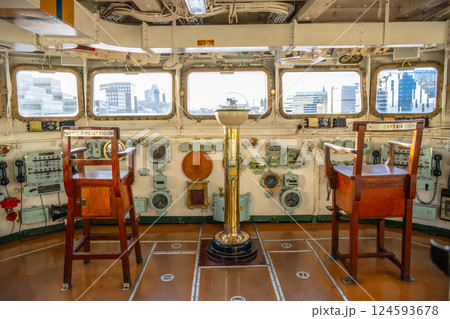 Visitors can explore the captain's bridge aboard HMS Belfast in London. The historic naval ship provides a glimpse into naval operations and maritime history through its authentic displays. Visitors can explore the captain's bridge aboard HMS Belfast in London. The historic naval ship provides a glimpse into naval operations and maritime history through its authentic displays. 124593678