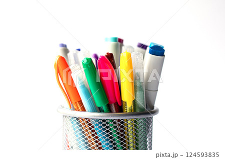 Colorful pens in a mesh holder on a white background close-up 124593835